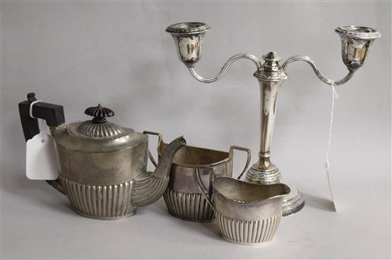 A silver three-piece tea service and a two-branch candelabra